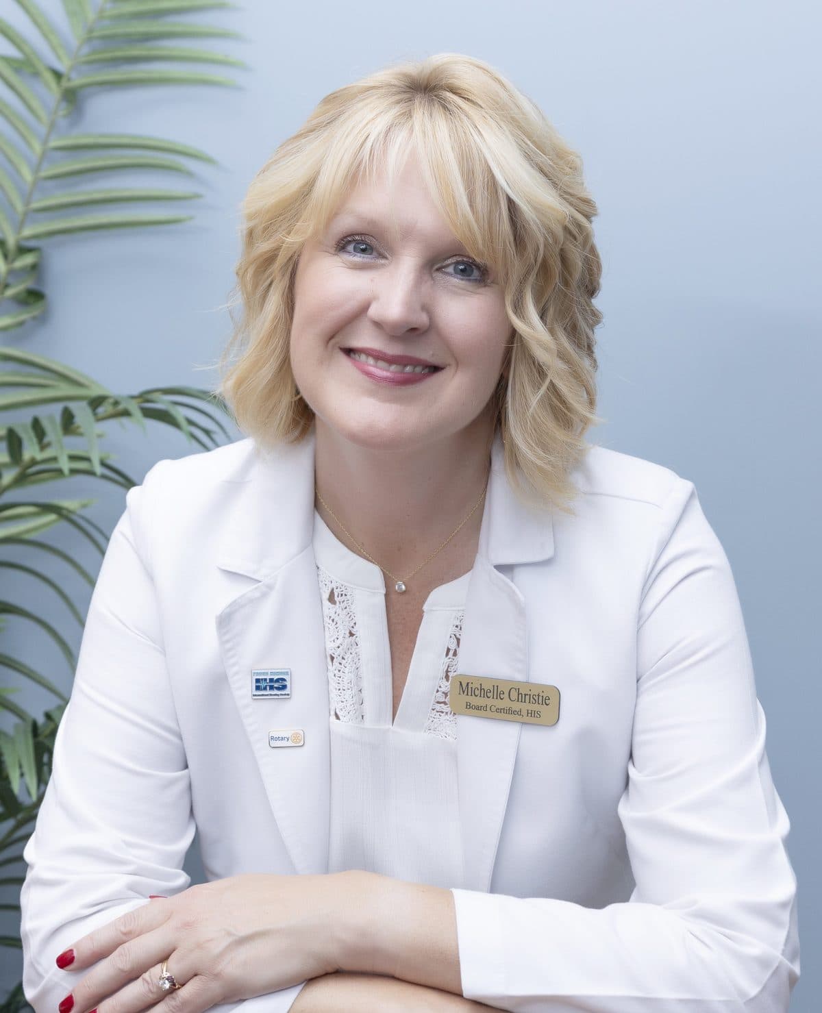 Michelle Christie, owner of Clarity, smiling in her white coat