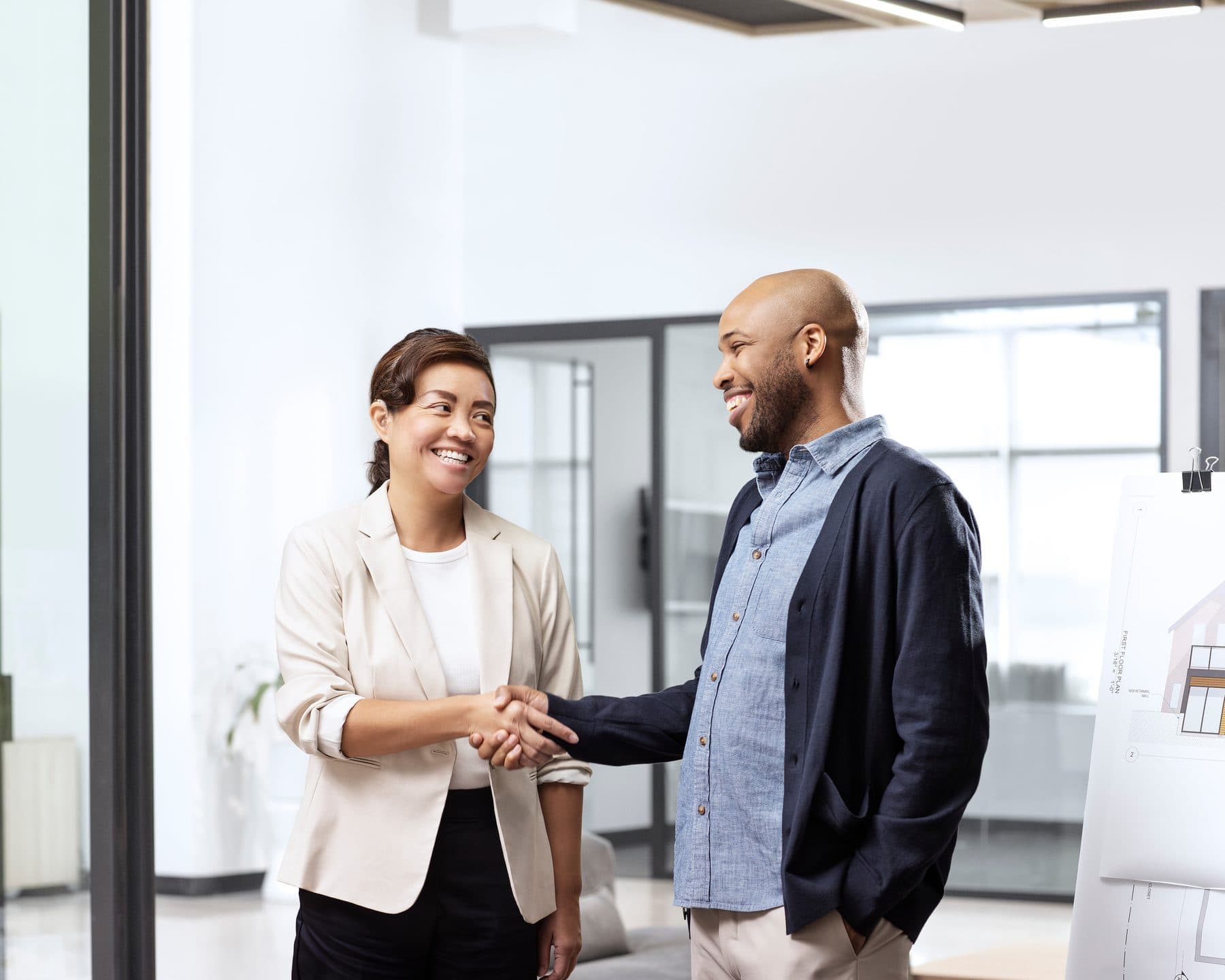 A businesswoman shaking hands and smiling during a meeting