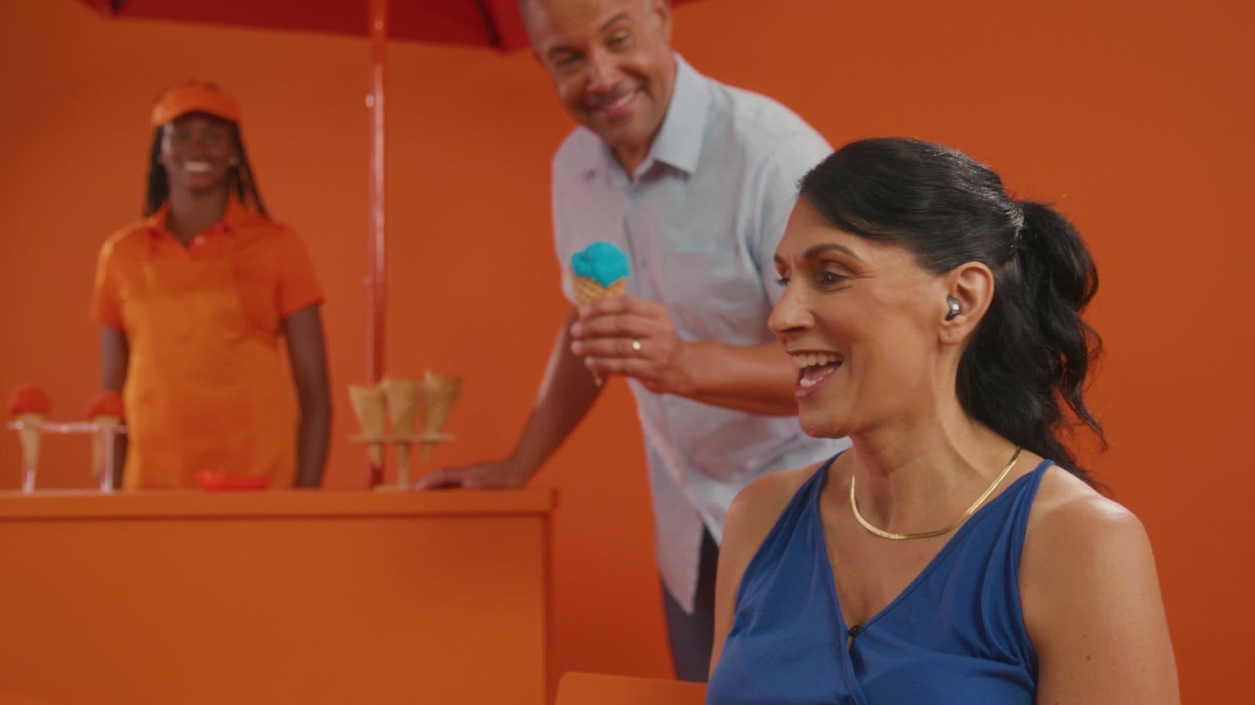 Friends chatting and laughing in a bright, colorful setting